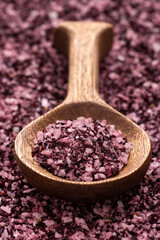 Natural hibiscus salt in wooden spoon - fine crystals for seasoning