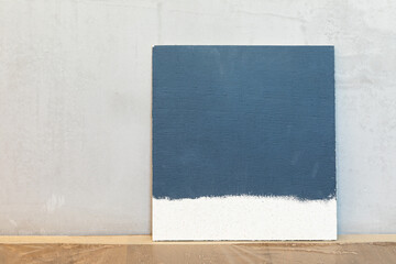 Fototapeta premium Grey color sampler at a blank plaster wall