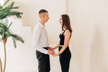 Young couple girl and boy in the studio modern lifestyle portrait. Love and relationship