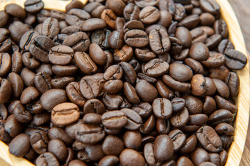 Fototapeta premium coffee beans in heart-shaped tra,y representing love of coffee