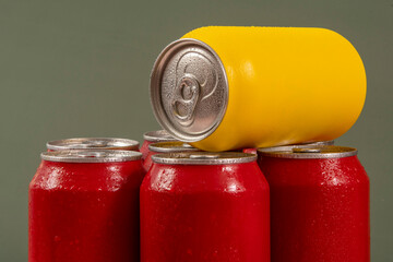 Cold red soda cans with a yellow one for conceptual use