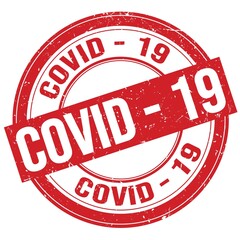 COVID - 19 text written on red round stamp sign