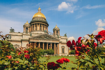 Panoramic view on Saint Isaac's Cathedral. Isaakievskiy Sobor with green lawn and red roses in summer, St. Petersburg, Russia. High quality photo