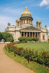 Panoramic view on Saint Isaac's Cathedral. Isaakievskiy Sobor with green lawn and red roses in summer, St. Petersburg, Russia. vertical photo. High quality photo