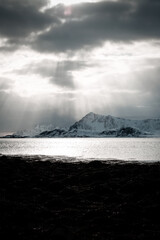 Unbelievable conditions in Lofoten, Norway. Playing lights, sun with clouds with mountains, amazing epic scenery during sunset 