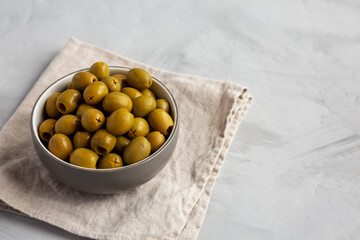 Marinated Green Pitted Olives in a Bowl, side view.