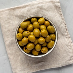 Marinated Green Pitted Olives in a Bowl, top view. Flat lay, overhead, from above.