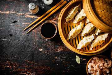 Hot dumplings gyoza in a bamboo steamer.