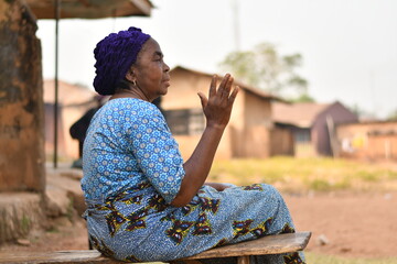 elderly african woman waving at someone
