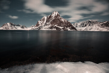Unbelievable conditions in Lofoten, Norway. Playing lights, sun with clouds with mountains, amazing epic scenery during sunset 
