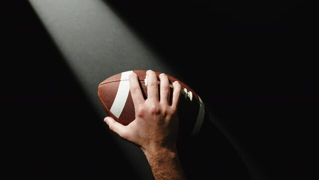 Hand Holding A Football ball