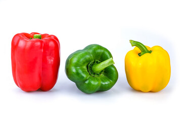 Red , green and yellow bell peppers isolated on white background