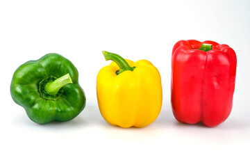 Red , green and yellow bell peppers isolated on white background