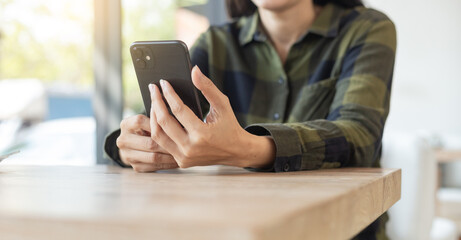 woman using cell phone hand holding mobile texting message contact us.chatting,search internet information.technology device communication connecting