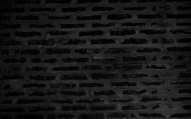 Black wall background The surface of the brick dark jagged. Abstract black wall background. Old brick black colour wall. Vintage background