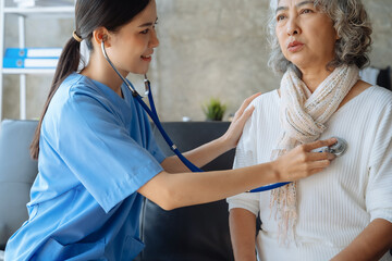 Doctor with stethoscope examining elderly patient with examination, healthcare and medical concept.
