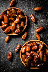Two plates of dates on the table. 