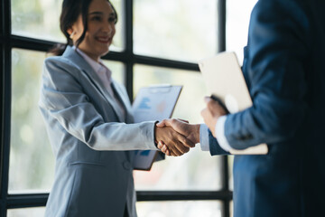 Asian businesspeople shaking hands, agree with the result of the meeting.