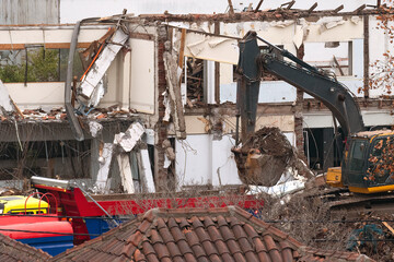 Old house demolition with an excavator.