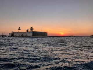 View of the sea from a sunset in summer, with the Fort of São Marcelo in Salvador, Bahia, Brazil.