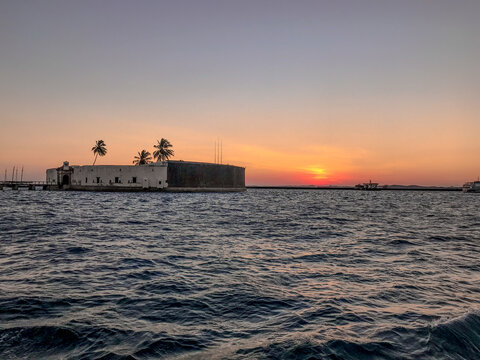 View of the sea from a sunset in summer, with the Fort of S&atilde;o Marcelo in Salvador, Bahia, Brazil.