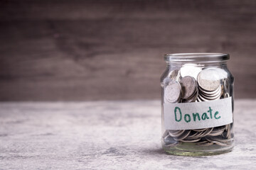 Glass jar with coins, monetary donations.Copy space