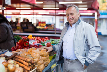 Middle aged man buying vegetables