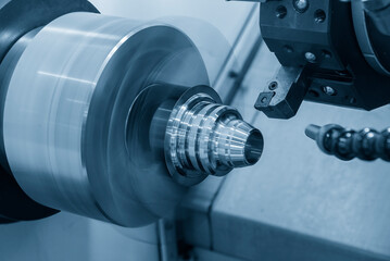 The  CNC lathe machine forming  cutting the metal cone shape parts.
