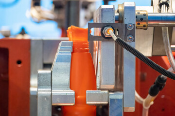 The orange bottle container manufacturing process by blow mold machine.