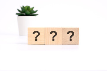 three question sign on wooden cubes on white background. business concept
