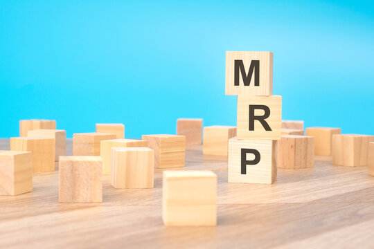 MRP - short for Marketing Research Planning - written on a wooden cube, business concept. blue background. can be used for business, marketing, education, financial concept. Selective focus.