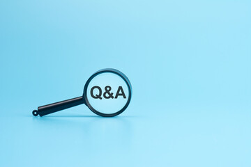look at the text Q and A through a magnifying glass on a blue background