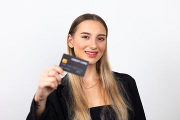 Happy caucasian female holding plastic bank credit card on hand. Professional company business woman over white wall background