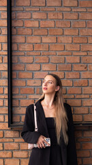 Portrait beautiful business woman model posing on red Brick wall