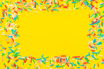 greeting wreath of colorful sprinkles on yellow background, festive invitation for Valentines day,...