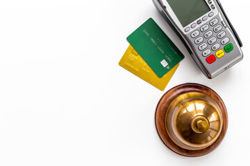 Hotel payment concept with service bell and payment terminal