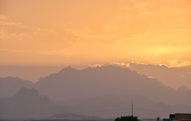 Sunset landscape with dark mountain peaks in egyptian desert