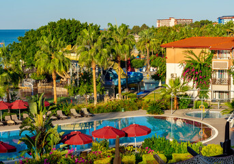 Fototapeta premium Palm trees and swimming pool in hotel in south Turkey