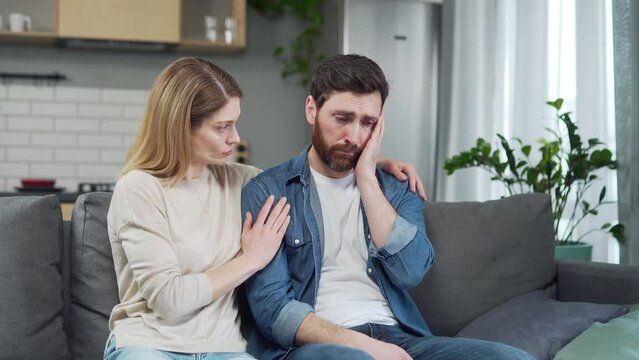 wife will support the husband in difficult moments of life woman trying to apologize to offended worried man after family conflict calms with serious problems at work or personal mental health crisis