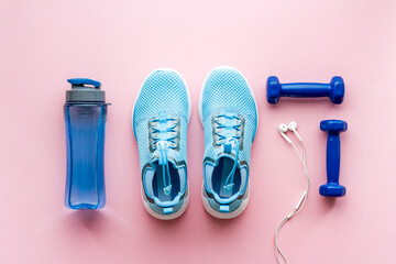 Sport fitness tools - sneakers and dumbbells, top view