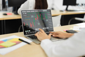 Successful of business trader investor woman use technology laptop trading graph of block chain stock market cryptocurrency investment selling and buy with price chart data graph