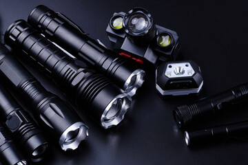Set of black pocket tactical flashlights isolated on black background