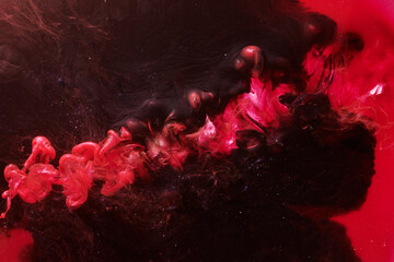 Red black abstract ocean background. Splashes and waves of paint under water, clouds of smoke in motion