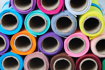 Multicolored soft felt textile material, fabric texture in rolls closeup