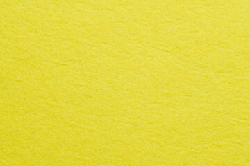 Soft felt textile material yellow color, colorful texture flap fabric background closeup