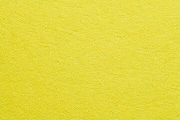 Soft felt textile material yellow color, colorful texture flap fabric background closeup