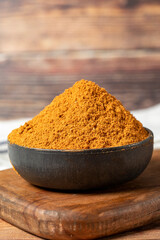 Meatball spice in bowl on rustic table. Meatball seasoning is a spice mix consisting of cumin, coriander, ground red pepper, thyme, black pepper, onion, garlic and dried parsley. Dry spice concept