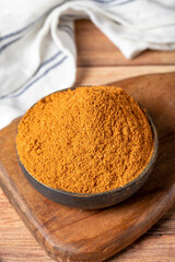 Meatball spice in bowl on rustic table. Meatball seasoning is a spice mix consisting of cumin, coriander, ground red pepper, thyme, black pepper, onion, garlic and dried parsley. Dry spice concept