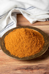Meatball spice in bowl on rustic table. Meatball seasoning is a spice mix consisting of cumin, coriander, ground red pepper, thyme, black pepper, onion, garlic and dried parsley. Dry spice concept
