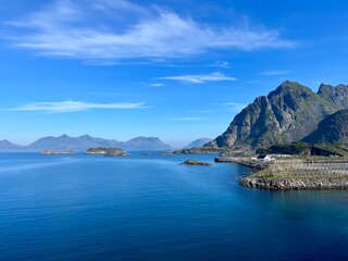 Blue calm ocean bay horizon, small rocky islands, blue sky